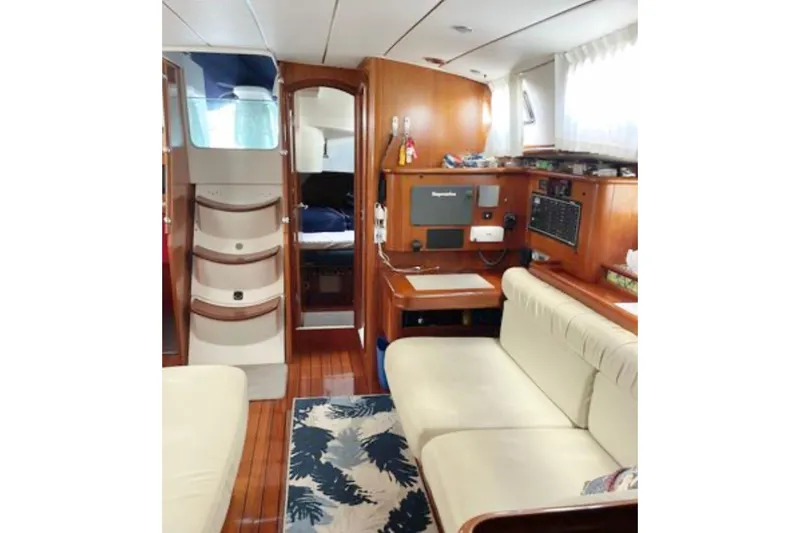 Slide: The Image of Interior of 2001 Beneteau Oceanis 461 yacht with cozy seating and navigation area. - 9