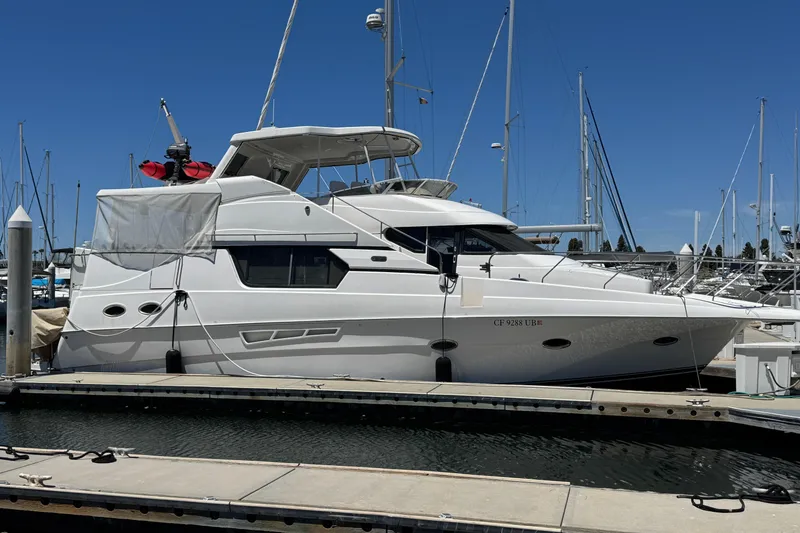 The Image of 2000 Silverton 453 Motor Yacht docked at marina under clear blue sky. - 0