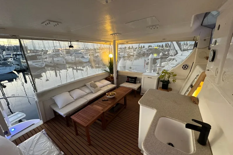 Slide: The Image of Luxurious 2000 Silverton 453 Motor Yacht interior with cozy seating and marina view. - 11
