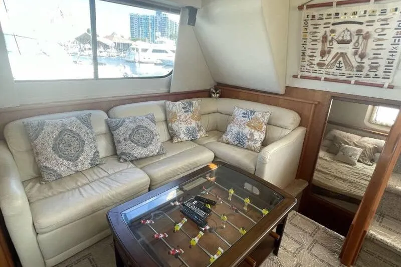 Slide: The Image of Luxurious interior of 2000 Silverton 453 Motor Yacht with plush seating and foosball table. - 16