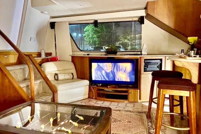 Slide: The Image of Luxurious interior of 2000 Silverton 453 Motor Yacht with cozy seating and entertainment area. - 17