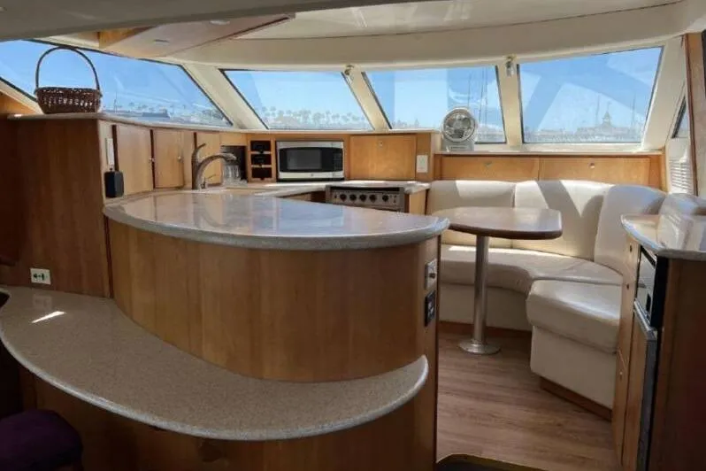 Slide: The Image of Interior of 2000 Silverton 453 Motor Yacht with modern kitchen and seating area. - 18