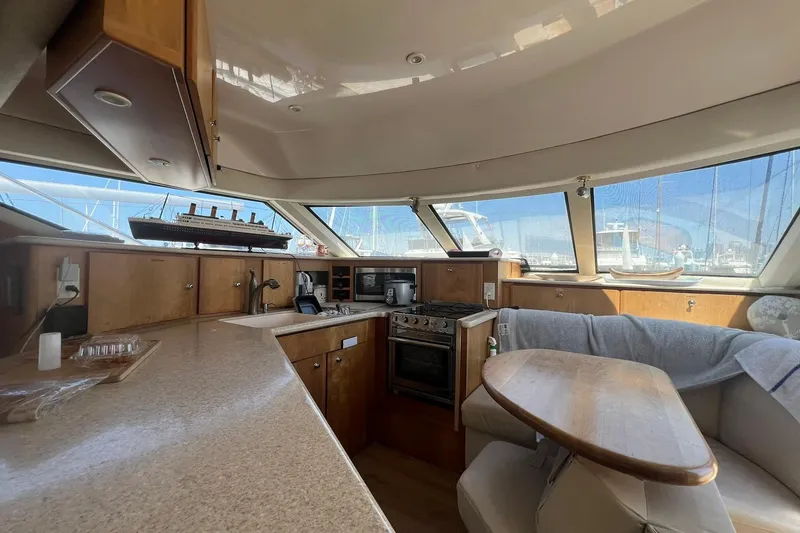 Slide: The Image of Interior of 2000 Silverton 453 Motor Yacht with kitchen and dining area. - 19
