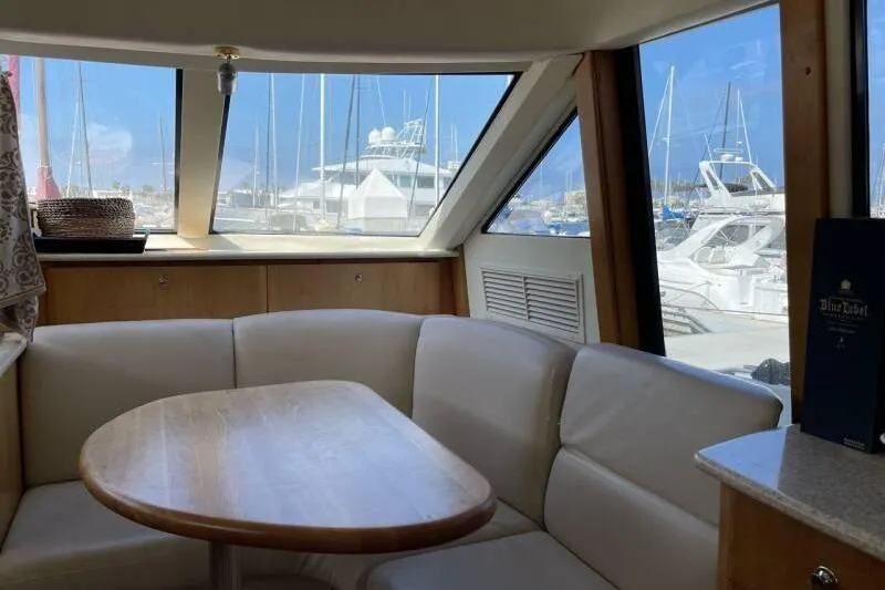 Slide: The Image of Interior of 2000 Silverton 453 Motor Yacht with marina view through large windows. - 21