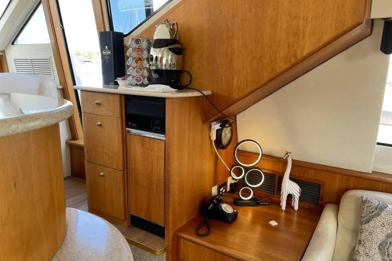 Slide: The Image of Interior of 2000 Silverton 453 Motor Yacht with wooden cabinetry and coffee maker. - 22
