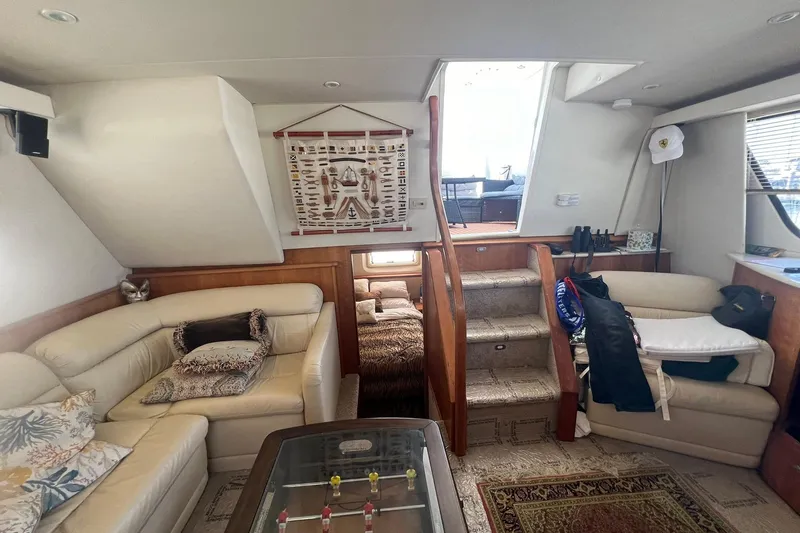 Slide: The Image of Interior of 2000 Silverton 453 Motor Yacht with cozy seating and nautical decor. - 25