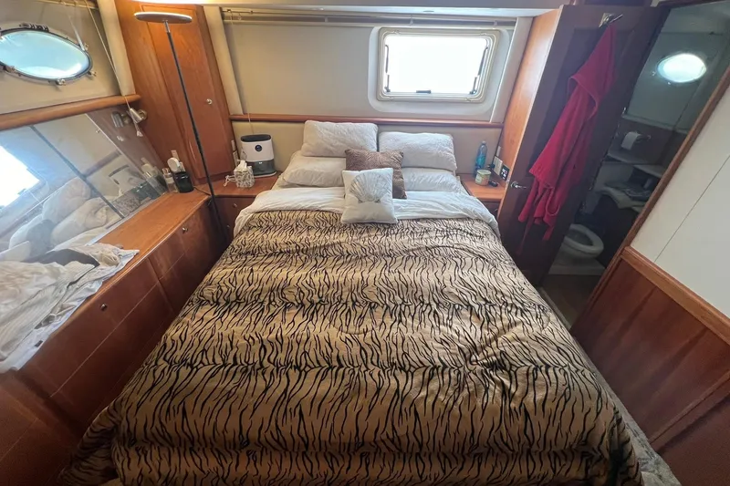 Slide: The Image of Cozy bedroom in 2000 Silverton 453 Motor Yacht with patterned bedding and wooden accents. - 26