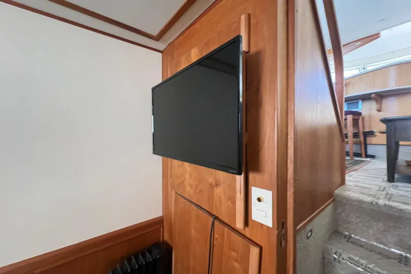 Slide: The Image of Flat-screen TV mounted on a wooden wall inside a 2000 Silverton 453 Motor Yacht. - 28