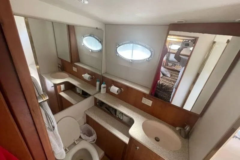 Slide: The Image of Bathroom interior of 2000 Silverton 453 Motor Yacht with sink, toilet, and mirror. - 29