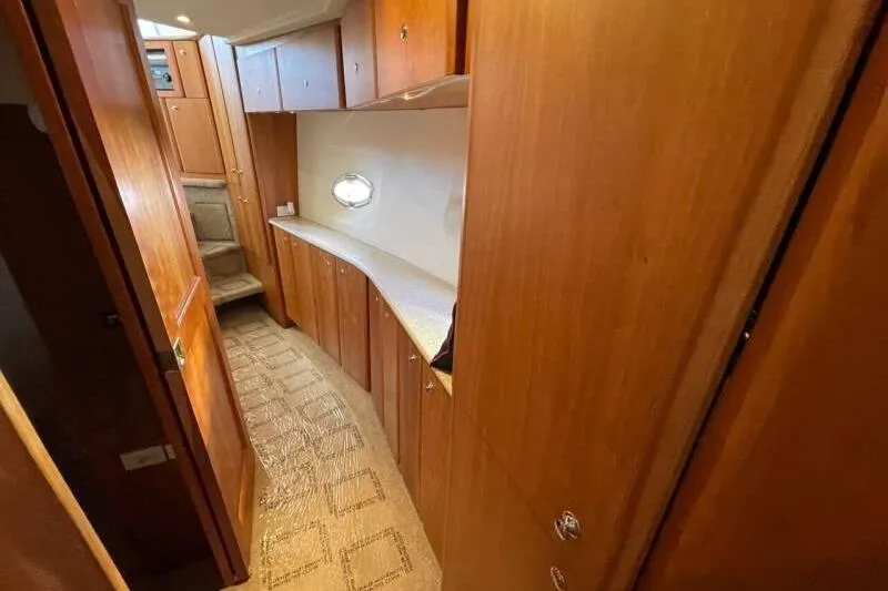 Slide: The Image of Interior of 2000 Silverton 453 Motor Yacht with wooden cabinetry and carpeted flooring. - 33