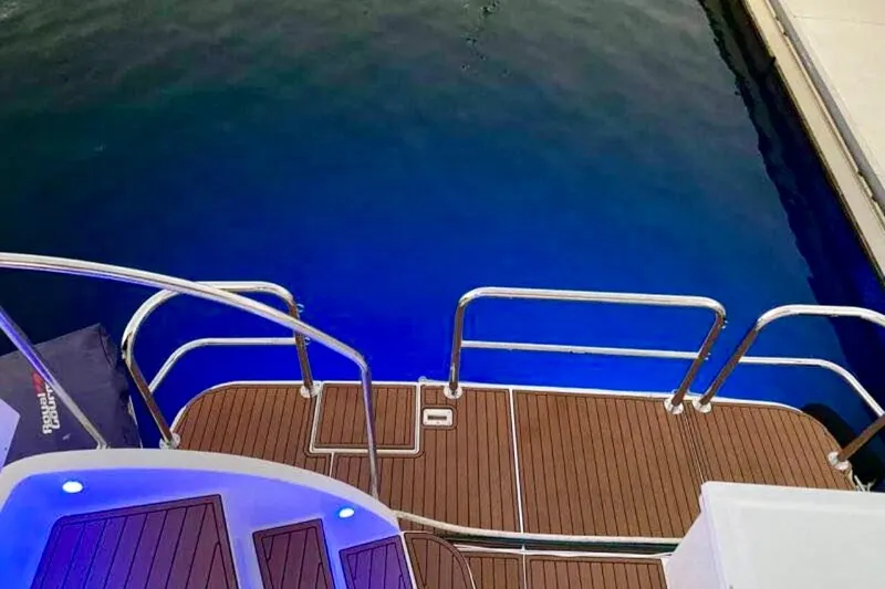 Slide: The Image of Stern view of 2000 Silverton 453 Motor Yacht with illuminated deck and water. - 4