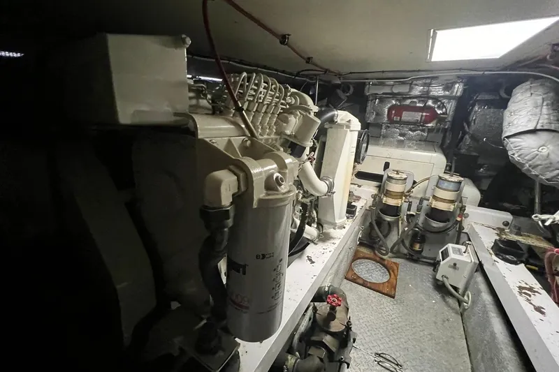 Slide: The Image of Engine room of a 2000 Silverton 453 Motor Yacht, showcasing mechanical components and equipment. - 48