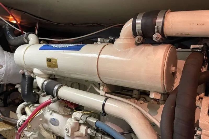 Slide: The Image of Engine compartment of a 2000 Silverton 453 Motor Yacht, showcasing detailed piping and components. - 49