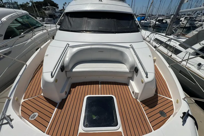 Slide: The Image of 2000 Silverton 453 Motor Yacht with spacious deck and seating at marina. - 5