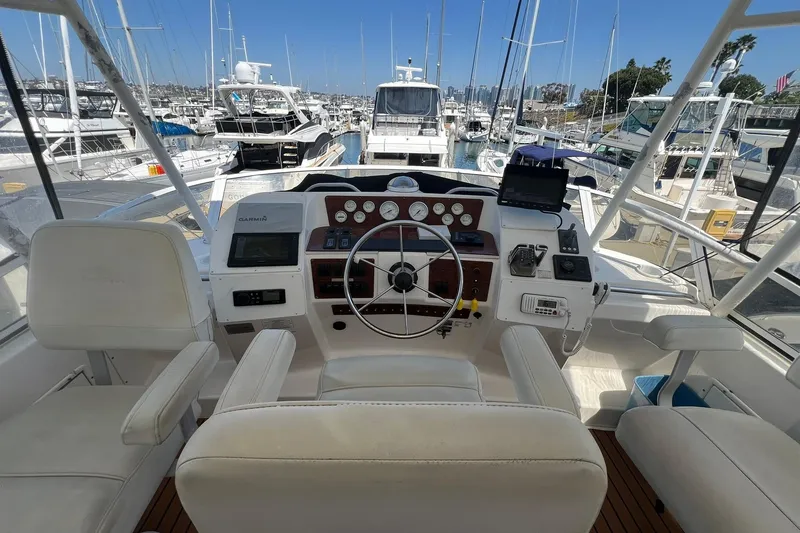 Slide: The Image of Cockpit view of a 2000 Silverton 453 Motor Yacht docked at a marina. - 7