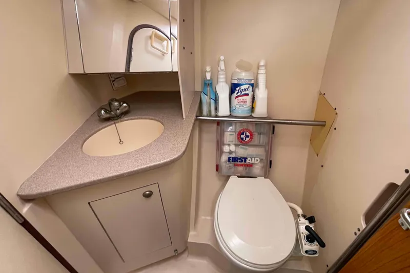 Slide: The Image of Compact bathroom in a 2000 Hunter 410 yacht with sink, toilet, and first aid kit. - 13