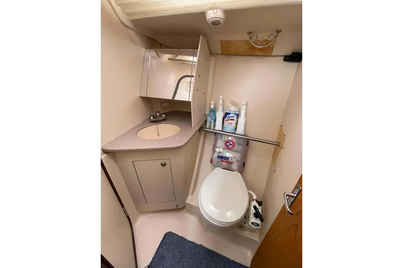 Slide: The Image of Compact bathroom in 2000 Hunter 410 yacht with sink, toilet, and storage. - 14