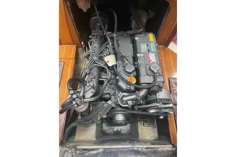 Slide: The Image of Engine compartment of a 2000 Hunter 410 sailboat, showcasing detailed mechanical components. - 16