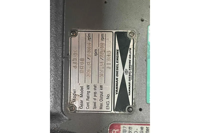 Slide: The Image of Plaque displaying Yanmar Diesel Engine specifications, model 4JH2E, on Hunter 410, year 2000. - 17