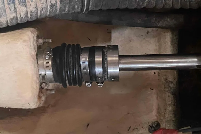 Slide: The Image of Close-up of a 2000 Hunter 410 boat shaft seal with hose clamps and rubber components. - 19