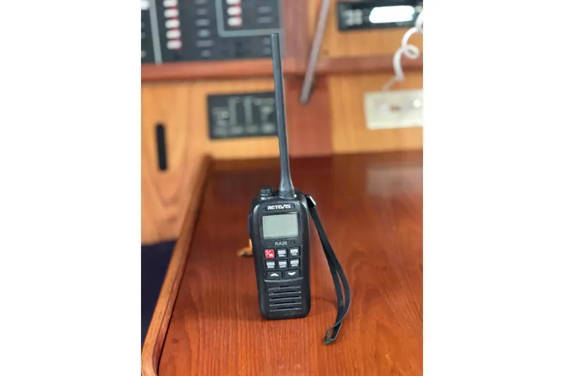 Slide: The Image of Handheld radio on wooden surface inside a 2000 Hunter 410 boat. - 26