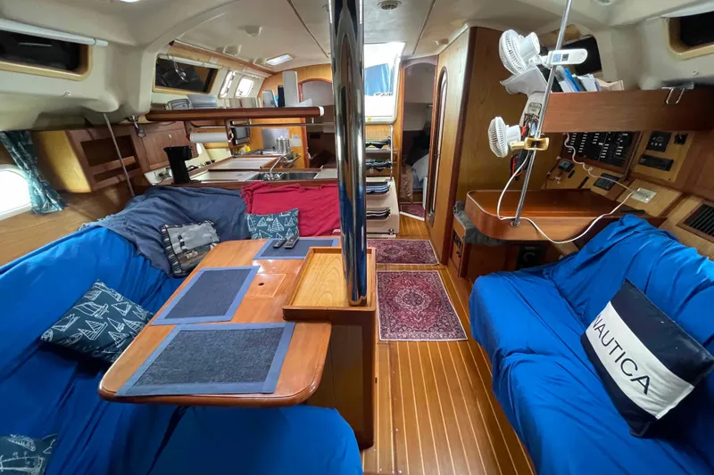 Slide: The Image of Interior of a 2000 Hunter 410 sailboat with cozy seating and nautical decor. - 28