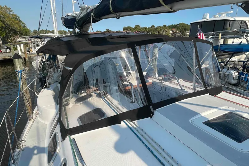 Slide: The Image of Sailboat Hunter 410 (2000) with black canopy docked at marina. - 3