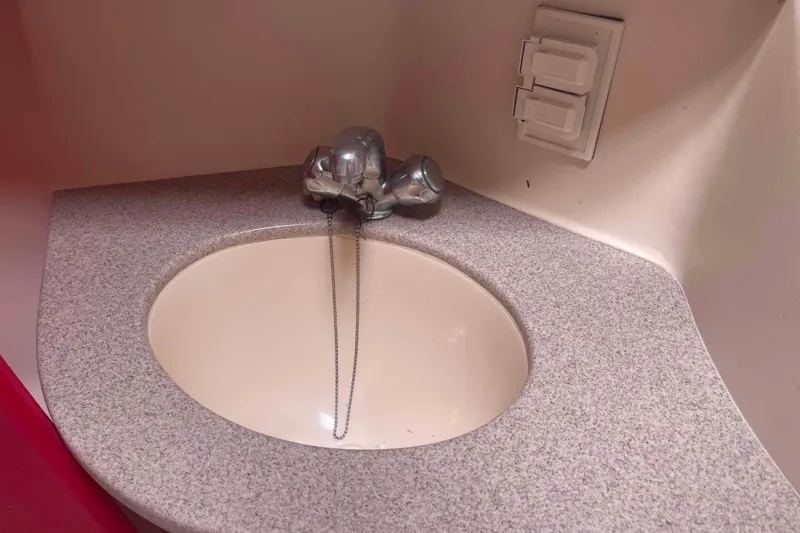 Slide: The Image of Small bathroom sink with chrome faucet in a 2000 Hunter 410 model. - 33
