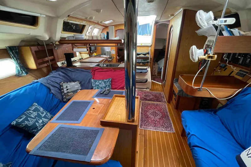 Slide: The Image of Interior of a 2000 Hunter 410 sailboat with cozy seating and wooden finishes. - 37