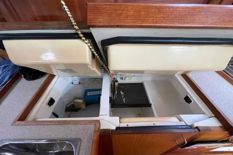 Slide: The Image of Open storage compartments in a 2000 Hunter 410 boat interior. - 41