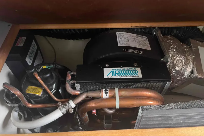 Slide: The Image of Marine air conditioning system in a 2000 Hunter 410 boat, featuring copper piping and insulation. - 43