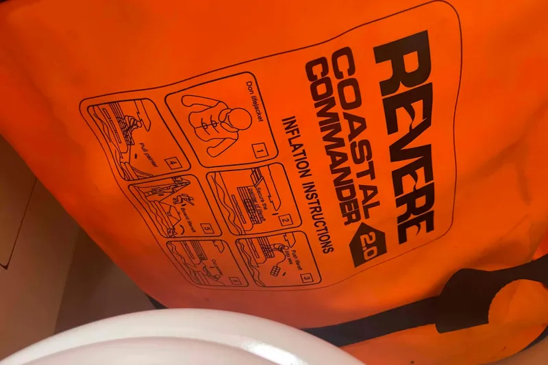 Slide: The Image of Orange Revere Coastal Commander 2.0 life raft with inflation instructions, Hunter 410, 2000 model. - 45