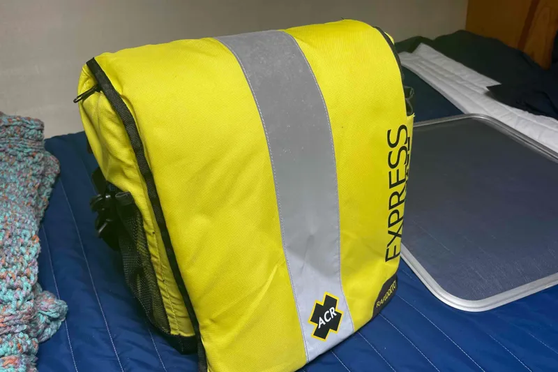 Slide: The Image of Yellow ACR Express bag on blue bedspread, Hunter 410 model, year 2000. - 47