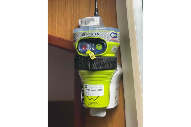 Slide: The Image of Emergency locator beacon mounted on a wooden surface, Hunter 410 model, year 2000. - 48