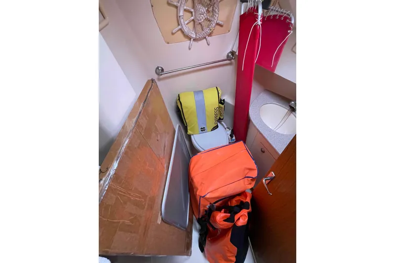 Slide: The Image of Small bathroom with bags and nautical decor on a 2000 Hunter 410 boat. - 49