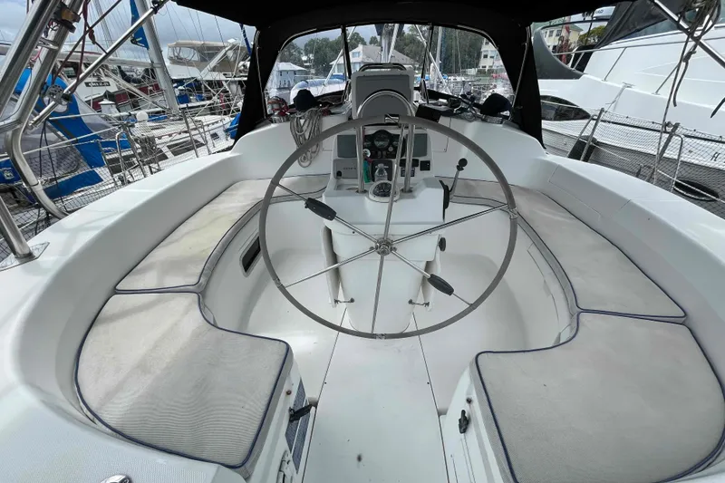 Slide: The Image of Spacious cockpit of a 2000 Hunter 410 sailboat with a large steering wheel. - 52