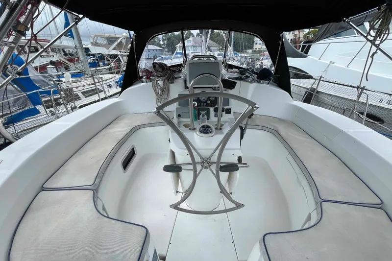 Slide: The Image of Cockpit of a 2000 Hunter 410 sailboat with steering wheel and navigation instruments. - 53