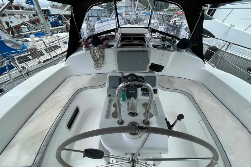 Slide: The Image of Cockpit of a 2000 Hunter 410 sailboat with steering wheel and navigation equipment. - 54