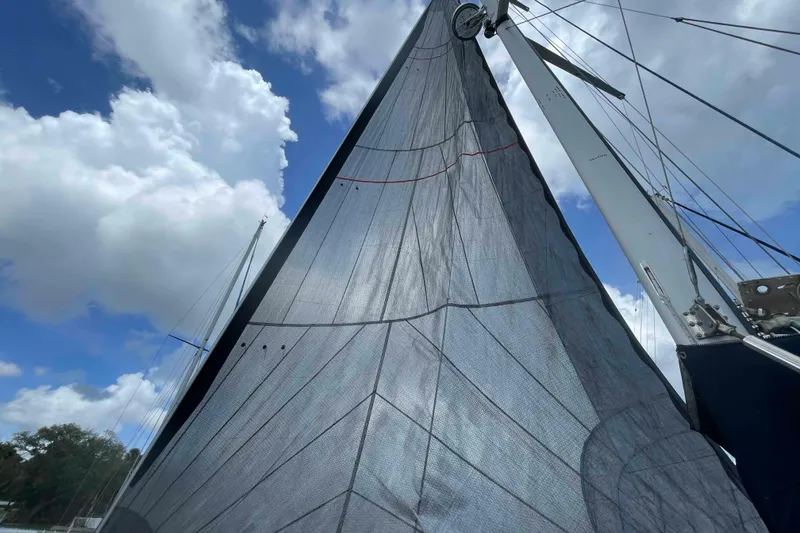 Slide: The Image of Sail of a 2000 Hunter 410 yacht against a cloudy blue sky. - 61