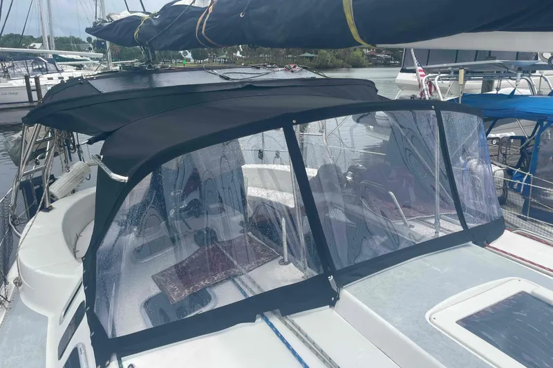 Slide: The Image of Sailboat with black canopy, Hunter 410 model, docked at marina, year 2000. - 67