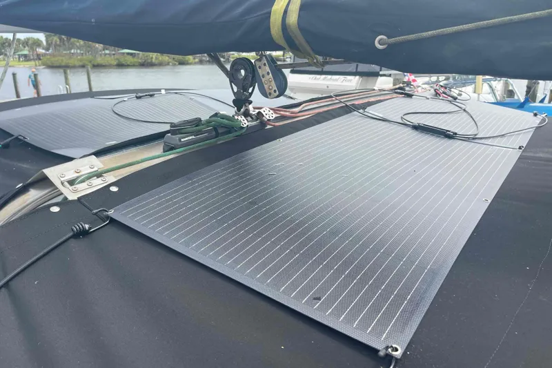Slide: The Image of Solar panels on a 2000 Hunter 410 sailboat, docked near water. - 68