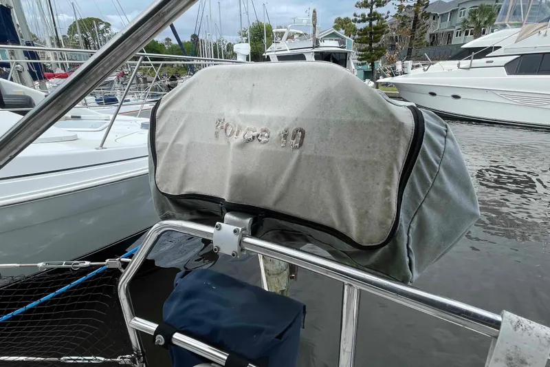 Slide: The Image of Boat engine cover labeled "Force 10" on a Hunter 410, year 2000, docked at marina. - 72