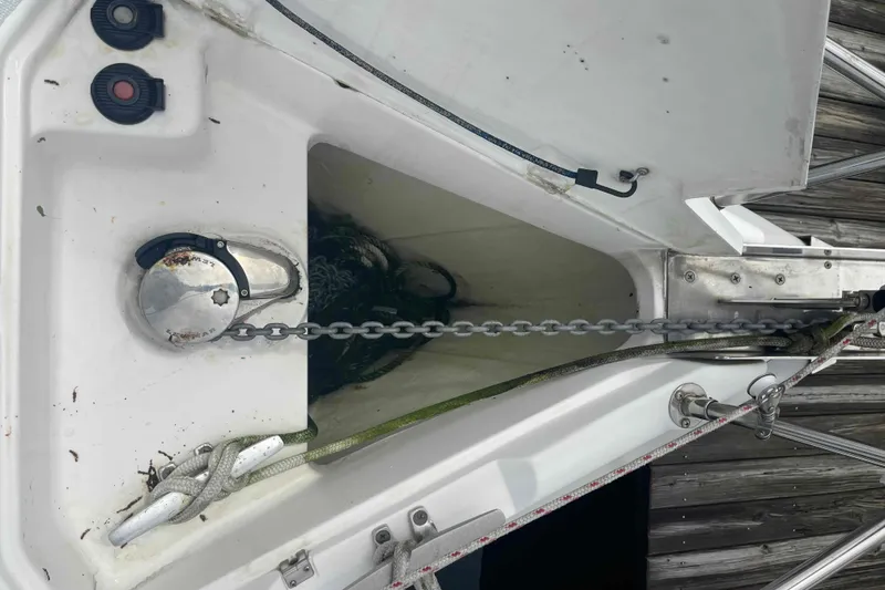 Slide: The Image of Anchor chain compartment on a 2000 Hunter 410 sailboat, featuring winch and rope details. - 75
