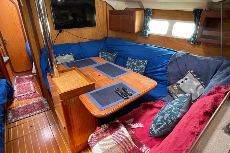 Slide: The Image of Cozy interior of a 2000 Hunter 410 sailboat with blue and red accents. - 8