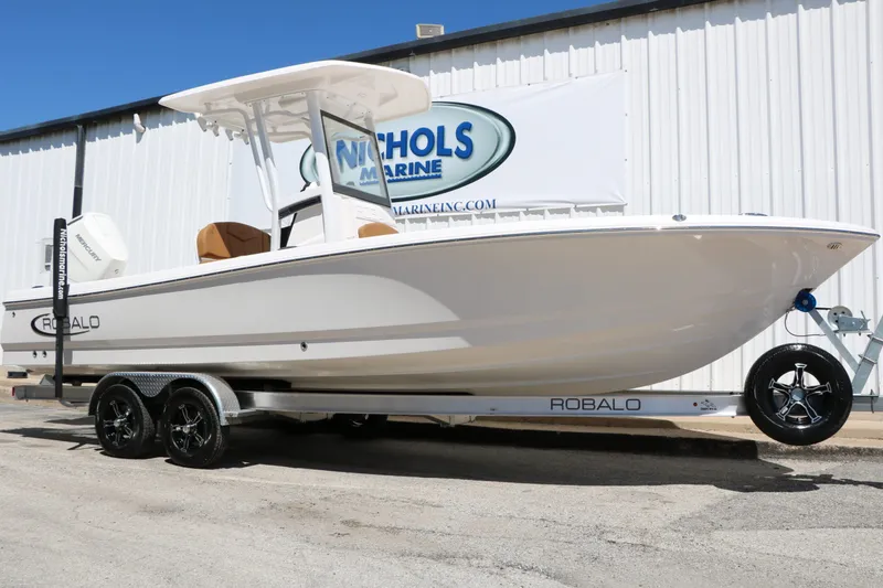 The Image of 2026 Robalo 246 Cayman boat on trailer in front of building. - 1