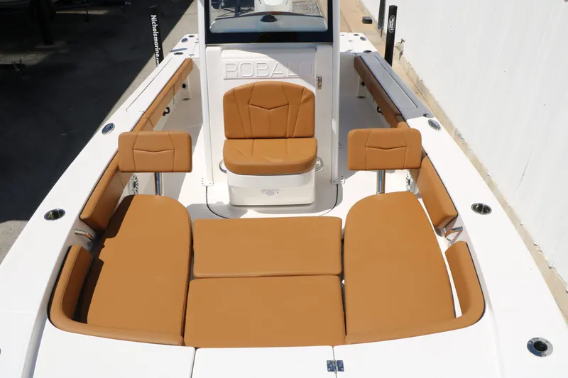 Slide: The Image of Interior view of 2026 Robalo 246 Cayman with brown seating. - 25