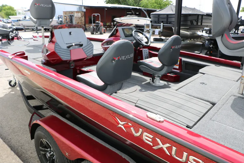 Slide: The Image of Red Vexus AVX 1985s boat, 2026 model, featuring gray seats. - 24