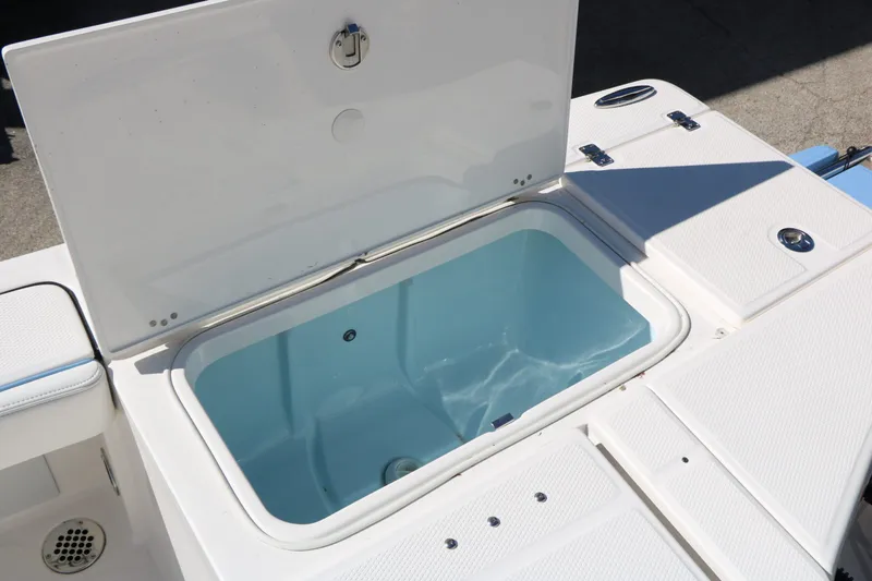 Slide: The Image of Robalo 226 Cayman 2026 boat with open storage compartment. - 37