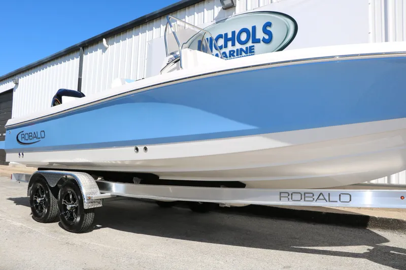 Slide: The Image of 2026 Robalo 226 Cayman boat on trailer outside building. - 42