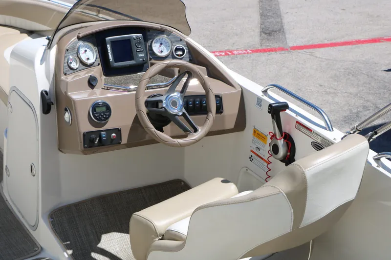 Slide: The Image of Interior view of a 2015 Stingray 192 SC boat helm. - 23